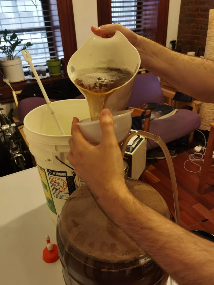 pouring guile into fermented beer